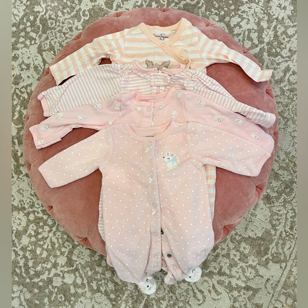 Set of four newborn onesies. One is 0-3mo. Various brands